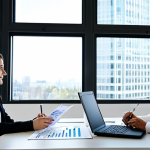 **

"A professional financial advisor, fully clothed in business attire, helping a young couple plan their retirement with index funds. They are sitting at a bright, modern office desk reviewing charts and graphs. Safe for work, appropriate content, professional setting, perfect anatomy, natural proportions, family-friendly."

**
